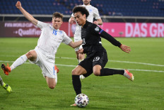 Iceland's defender Alfons Sampsted and Germany's midfielder Leroy Sane (R) vie for the ball during the FIFA World Cup Qatar 2022 qualification football match Germany v Iceland in Duisburg, western Germany on March 25.