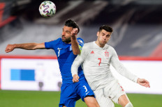 Spain's forward Alvaro Morata (R) challenges Greece's defender Georgios Tzavelas during the FIFA World Cup Qatar 2022 qualification football match between Spain and Greece on March 25, 2021 at Los Carmenes stadium in Granada.