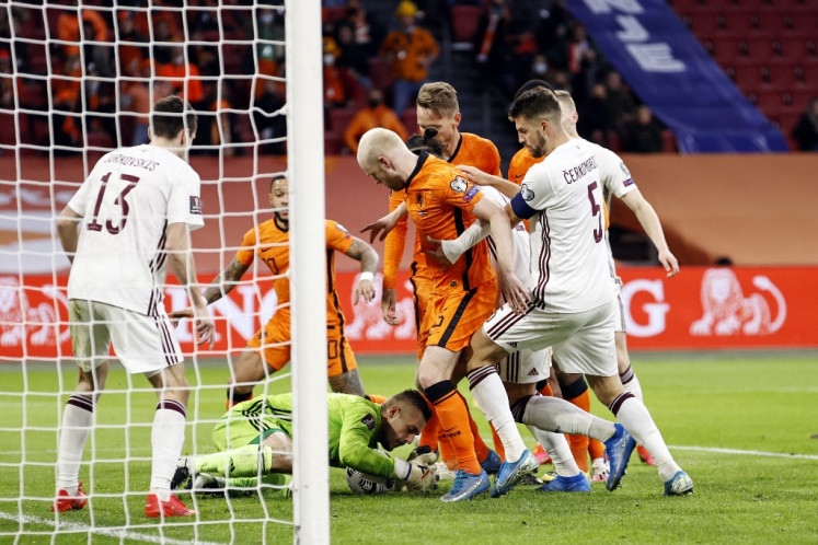 (From left) Latvia's midfielder Raivis Jurkovskis, Latvia's goalkeeper Roberts Ozols, Dutch's midfielder Davy Klaassen, Dutch's center Luuk de Jong, Latvia's defender Antonijs Cernomordijs, Dutch's defender Denzel Dumfries fight for the ball during their World Cup qualifying Group G match between the Netherlands and Latvia at the Johan Cruijff Arena in Amsterdam on March 27, 2021. Some 5000 spectators, all with a negative Covid-19 test result, attended the match as part of the so-called fieldlabs intended as experiments to show whether events during corona time can take place safely. 