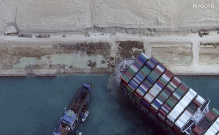 This satellite imagery released by Maxar Technologies shows the MV Ever Given container ship in the Suez Canal on the morning of March 28, 2021. Hope rose on March 28, 2021 that salvage efforts would free a mammoth container ship blocking the Suez Canal for six days, crippling international trade and causing multi-million-dollar losses. The MarineTraffic and VesselFinder applications said two tugboats were heading to the vital waterway to bolster the salvage operation, while experts pinned hope on a high tide to help refloat the vessel.