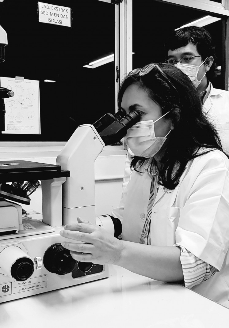 Indah Arsyad looks through a microscope at the Indonesian Institute of Sciences (LIPI) Research Center for Oceanography while researching oxygen for ‘The Breath’.

