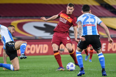 Roma's Bosnian forward Edin Dzeko kicks the ball during the Italian Serie A football match AS Roma vs Napoli on March 21, 2021 at the Olympic stadium in Rome.
