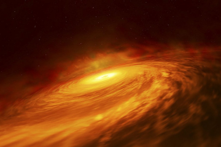 A handout picture released by the European Space Agency (ESA) on July 11, 2019 shows an artist’s impression of the peculiar thin disc of material circling a supermassive black hole at the heart of the spiral galaxy NGC 3147, located 130 million light-years away. Astronomers using the NASA/ESA Hubble Space Telescope have observed an unexpected thin disc of material encircling a supermassive black hole at the heart of the spiral galaxy NGC 3147, located 130 million light-years away. The presence of the black hole disc in such a low-luminosity active galaxy has astronomers surprised. Black holes in certain types of galaxies such as NGC 3147 are considered to be starving as there is insufficient gravitationally captured material to feed them regularly