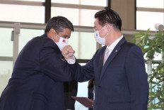 Palau President Surangel Whipps receives an elbow greeting from Taiwan Foreign Minister Joseph Wu (right) after arriving at the Taoyuan International Airport on March 28, 2021.
