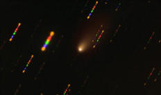 This handout image made available on March 30, 2021 by the European Southern Observatory shows the comet 2I/Borisov passing near the Sun taken with the FORS2 instrument on ESO's Very Large Telescope in late 2019. Since the comet was travelling at breakneck speed, around 175 000 kilometres per hour, the background stars appeared as streaks of light as the telescope followed the comet's trajectory. The colours in these streaks give the image some disco flair and are the result of combining observations in different wavelength bands, highlighted by the various colours in this composite image.