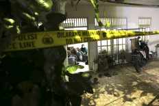 Police tape seals off the family home of the armed woman who was shot dead by authorities while attacking Indonesia's National Police headquarters, in Jakarta on March 31, 2021.