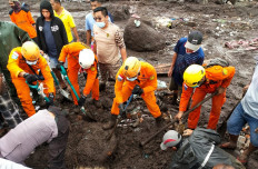 This handout photo taken on Monday and released by the National Search and Rescue Agency (BASARNAS) shows rescuers looking for survivors in Nelemamadike village, East Flores, after torrential rains triggered floods and landslides in Indonesia and Timor Leste.