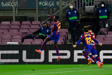 Barcelona's French forward Ousmane Dembele (C) celebrates after scoring during the Spanish League football match between FC Barcelona and Real Valladolid FC at the Camp Nou stadium in Barcelona on April 5, 2021.