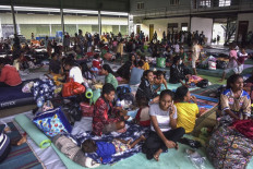 Residents take refuge at an evacuation centre after fleeing their damaged homes in Dili on April 5, 2021, after torrential rains triggered floods and landslides in Indonesia and East Timor.
