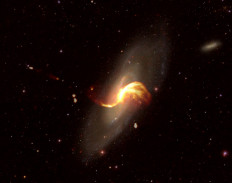 This handout released by Paris Observatory - PSL on February 19, 2019, shows an optical image of the M106 galaxy stacked on an image of the galaxy's emissions of material (in orange) taken with the Low-Frequency Array (LOFAR) radio telescope. The European LOFAR radio telescope on April 7 revealed, via a series of studies, images of unprecedented precision of tens of thousands of star-forming galaxies in the young Universe.
 