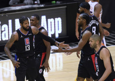  Paul George #13 of the LA Clippers celebrates a lead with Kawhi Leonard #2 after a tinmeout during the fourth quarter in a 113-103 Clippers win over the Phoenix Suns at Staples Center on April 08, 2021 in Los Angeles, California.