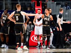 Trae Young #11 of the Atlanta Hawks high fives Kevin Huerter #3 during the game against the Chicago Bulls on April 9, 2021 at State Farm Arena in Atlanta, Georgia.