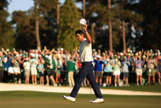 Hideki Matsuyama of Japan celebrates on the 18th green after winning the Masters at Augusta National Golf Club on April 11, 2021 in Augusta, Georgia. 