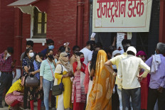 People stand in queues as they wait to register themselves for the Covid-19 coronavirus test at a testing centre in Allahabad on April 12, 2021 as India overtook Brazil as the country with the second-highest number of coronavirus infections. 