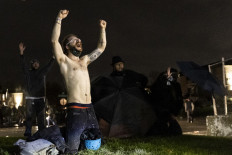 Demonstrators shout "Don't shoot" at the police after curfew as they protest the death of Daunte Wright who was shot and killed by a police officer in Brooklyn Center, Minnesota on April 12, 2021. A suburb of Minneapolis was under curfew early April 12, 2021 after US police fatally shot a young Black man, sparking protests not far from where a former police officer was on trial for the murder of George Floyd.Hundreds of people gathered outside the police station in Brooklyn Center, northwest of Minneapolis, with police later firing teargas and flash bangs to disperse the crowd, according to an AFP videojournalist.