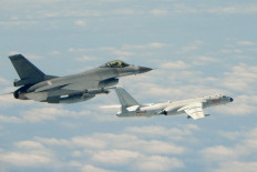 This handout photograph taken and released on May 11, 2018 by Taiwan's Defence Ministry shows a Republic of China (Taiwan) Air Force F-16 fighter aircraft (left) flying alongside a Chinese People's Liberation Army Air Force (PLAAF) H-6K bomber that reportedly flew over the Bashi Channel, south of Taiwan, and over the Miyako Strait, near Japan's Okinawa Island, in a drill. China sent fighter jets and other military aircraft near Taiwan on May 11 in the latest of a series of drills which Beijing has said are aimed at the island's 