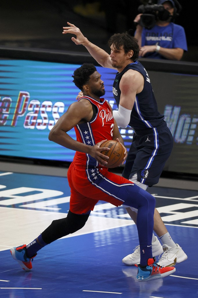 Joel Embiid #21 of the Philadelphia 76ers drives to the basket against Boban Marjanovic #51 of the Dallas Mavericks in the first half at American Airlines Center on April 12, 2021 in Dallas, Texas.