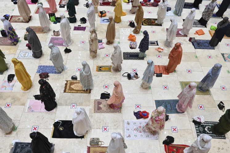Muslim women offer prayers on the first night of Ramadan at the Istiqlal grand mosque in Jakarta on April 12, 2021. 