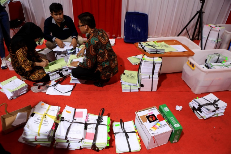 Final check: Officials from the General Elections Commission (KPU), the Elections Supervisory Agency (Bawaslu) and the Constitutional Court verify evidence related to the dispute over the 2019 legislative election results on July 5, 2019. 