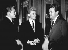 French actors Gerard Philipe (center) and Jean Marais (left) talk with US director Orson Welles in 1948 in Paris. 