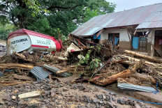 Debris left behind in the town of Adonara in East Flores on Monday after flash floods and landslides swept eastern Indonesia and neighboring East Timor .