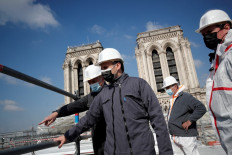 Macron scales Notre-Dame's rooftop two years after cathedral fire