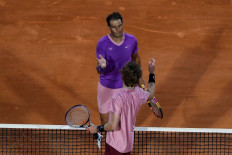 Spain's Rafael Nadal (Top) shakes hands with Russia's Andrey Rublev after their quarter final singles match on day seven of the Monte-Carlo ATP Masters Series tournament in Monaco on April 16, 2021.