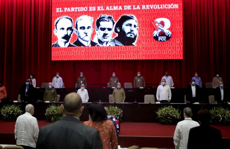 Handout picture taken from Cuban website www.cubadebate.cu showing Cuban First Secretary of the Communist Party Raul Castro (center), Cuban President Miguel Diaz-Canel (third-right) and other memebrs under a screen depicting (left-right) Cuban hero Jose Marti, founders of the PCC Carlos Balino and Julio Antonio Mella, and Cuban late leader Fidel Castro, reading “The party is the soul of revolution” during the opening session of the 8th Congress of the Cuban Communist Party at the Convention Palace in Havana, on April 16, 2021. The 8th Congress of the Cuban Communist Party (PCC) starting Friday will end over six decades of the government of Fidel and Raul Castro, giving way to a new generation.