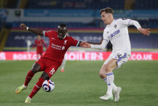Liverpool's Senegalese striker Sadio Mane (L) takes on Leeds United's Spanish defender Diego Llorente (R) during the English Premier League football match between Leeds United and Liverpool at Elland Road in Leeds, northern England on April 19, 2021.