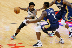 Kyrie Irving #11 of the Brooklyn Nets drives against Zion Williamson #1 of the New Orleans Pelicans during the first half at the Smoothie King Center on April 20, 2021 in New Orleans, Louisiana. 