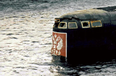 The conning tower of the Kursk nuclear submarine appears at the surface in the port of Roslyakovo, near Murmansk, 23 October 2001. The Kursk nuclear submarine surfaced for the first time 23 October 2001 after a number of still-unexplained explosions sank the vessel with 118 men on board in August 2000.