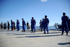 Police officers prepare to take part in the search operation for the KRI Nanggala-402 submarine at Celukan Bawang Port, Bali, on Thursday, the vessel went missing during an exercise on Wednesday. 