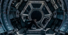 Shamier Anderson's character of an unplanned passenger in a spaceship sits at an observation deck.