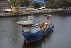 This handout photograph taken on April 22, 2021 and released by the Indian Navy, shows Indian Navy's Deep Submergence Rescue Vessel (DSRV) exiting the Visakhapatnam Port to join in the search for a decades-old Indonesian navy submarine that went missing off the coast of Bali with 53 crew aboard during regular exercises. 