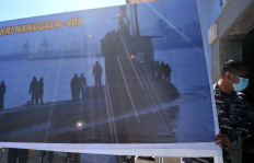 An Indonesian Navy seaman prepares an operation post of the search and rescue mission for the missing KRI Nanggala-402 submarine at I Gusti Ngurah Rai Airbase in Badung, Bali on April 23, 2021. The 44-year-old submarine, carrying 53 crew members on board, made its last contact at 3:00 a.m. on April 21 after the crew asked permission to dive into deeper water for a torpedo-firing exercise.