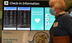 A woman proceeds to the check-in counter for New Zealand flights at Sydney International Airport on April 19, 2021, as Australia and New Zealand opened a trans-Tasman quarantine-free travel bubble. 