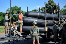 Members of an Indonesian marine amphibious reconnaissance squad prepare equipment for search operations at the Tanjungwangi port near the naval base in Banyuwangi, East Java province on April 25, 2021, as the military continues the search off the coast of neighbouring Bali island for the navy's KRI Nanggala submarine that went missing April 21 during a training exercise. 
