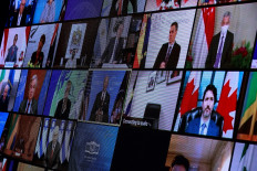 World leaders appear on the screen during a virtual Climate Summit, as seen from the East Room at the White House in Washington, DC, on Thursday.