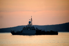 An Indonesian Navy ship sets sail at dawn from the naval base in Banyuwangi, East Java province on April 25, 2021, as the military continues search operations off the coast of Bali for the Navy's KRI Nanggala (402) submarine that went missing April 21 during a training exercise. 
