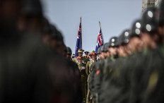 Australian and New Zealand soldiers stand behind Turkish soldiers during the ceremony celebrating the 99th anniversary of the Anzac Day in Canakkale on April 24, 2014. 