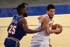 Devin Booker #1 of the Phoenix Suns heads for the net as Reggie Bullock #25 of the New York Knicks defends in the fourth quarter at Madison Square Garden on April 26, 2021 in New York City. 