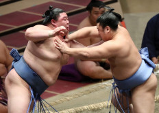 This photo taken on September 27, 2020 shows Japanese sumo wrestler Shodai (left) battling against lower-ranked wrestler Tobizaru of Japan to win the bout and finish with a 13-2 record on the final day to win the 15-day Autumn Grand Sumo Tournament in Tokyo. 