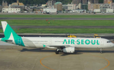 An Air Seoul plane sits on a tarmac.