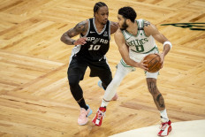 Jayson Tatum #0 of the Boston Celtics dribbles the ball while guarded by DeMar DeRozan #10 of the San Antonio Spurs at TD Garden on April 30, 2021 in Boston, Massachusetts. 