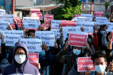 Unity: Protesters hold up posters in support of Myanmar’s National Unity Government (NUG) during a demonstration against the military coup on Global Myanmar Spring Revolution Day in Taunggyi, Shan state, Myanmar, on May 2, 2021.