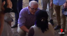 Australian Prime Minister Scott Morrison listens to a woman pleading him to help her family in Africa.