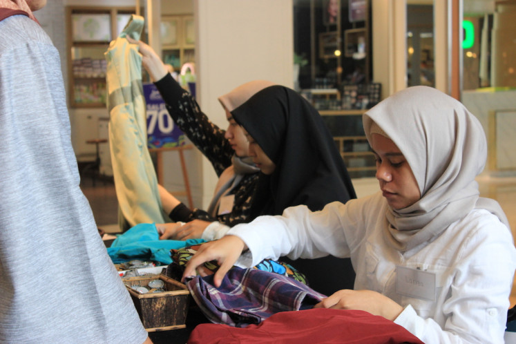 Trading clothes: The Tukar Baju team curating clothes for their event in August 2019. 