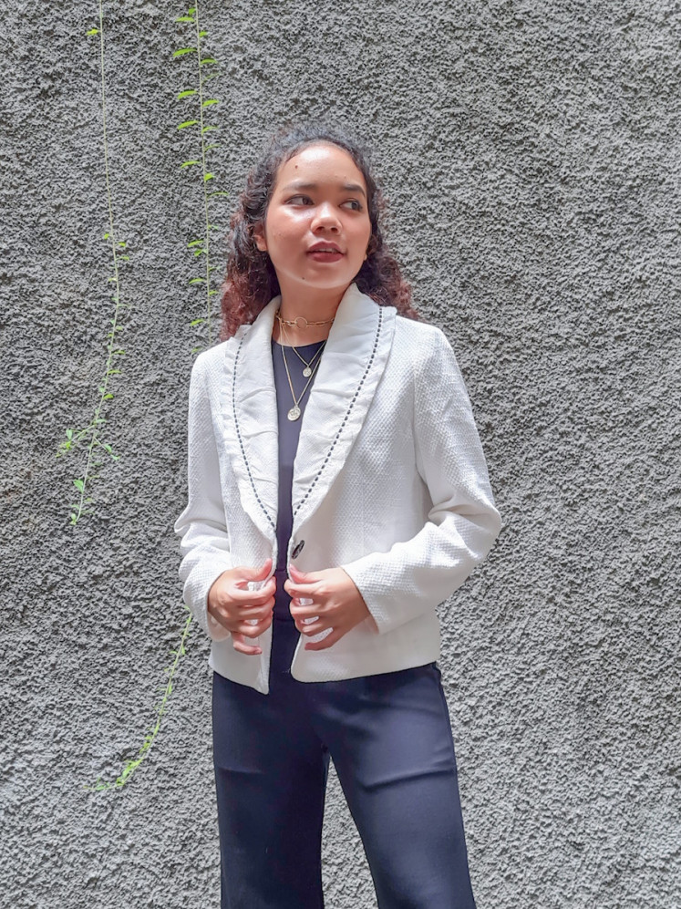 Preloved goods: Syeba showcasing a jacket sold at her second-hand clothing online shop.