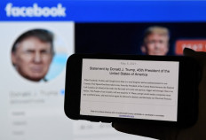 In this photo illustration, a phone screen displays the statement of former US President Donald Trump on his Facebook page background, on May 5, 2021, in Arlington, Virginia. Donald Trump said May 5, 2021 it was a 