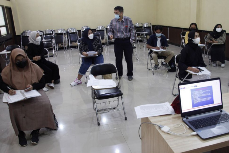 Learning by trial: Students try out a physically distanced classroom seating arrangement at 11 March University (UNS) in Surakarta, Central Java, during UNS' offline learning trial in April 2021. 